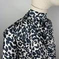 White satin polyester fabric coupon with a navy leopard print pattern 1,50m or 3m x 1,40m