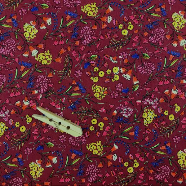 Coupon of polyester crepe fabric with a floral pattern on a burgundy background 3m x 1.40m