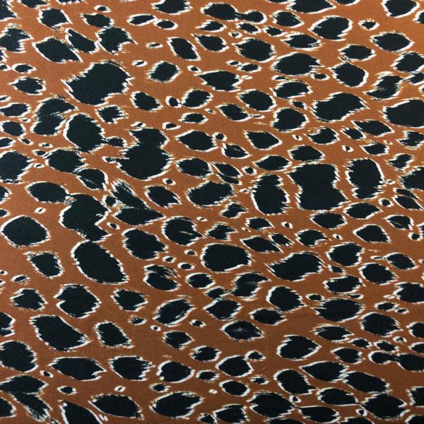 Fabric coupon in fluffy viscose twill with black spots on caramel background 1,50m or 3m x 1,40m
